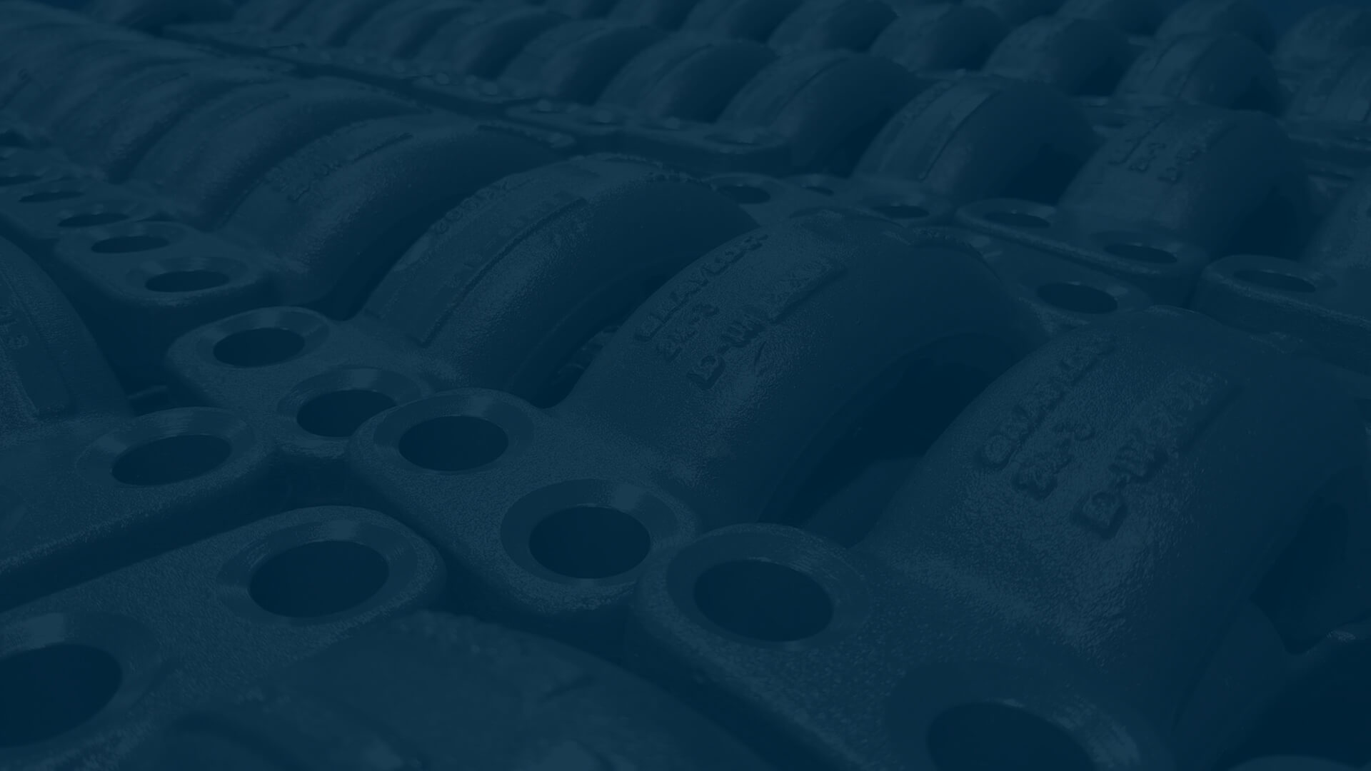 Rows and rows of Grayloc Clamp Connectors with a blue hue.