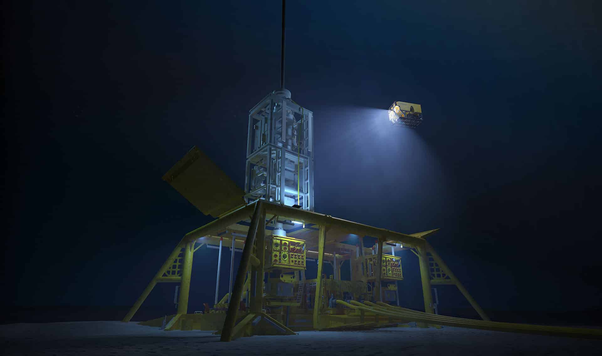 Subsea wellhead on a seabed template during installation, illuminated by an ROV underwater.