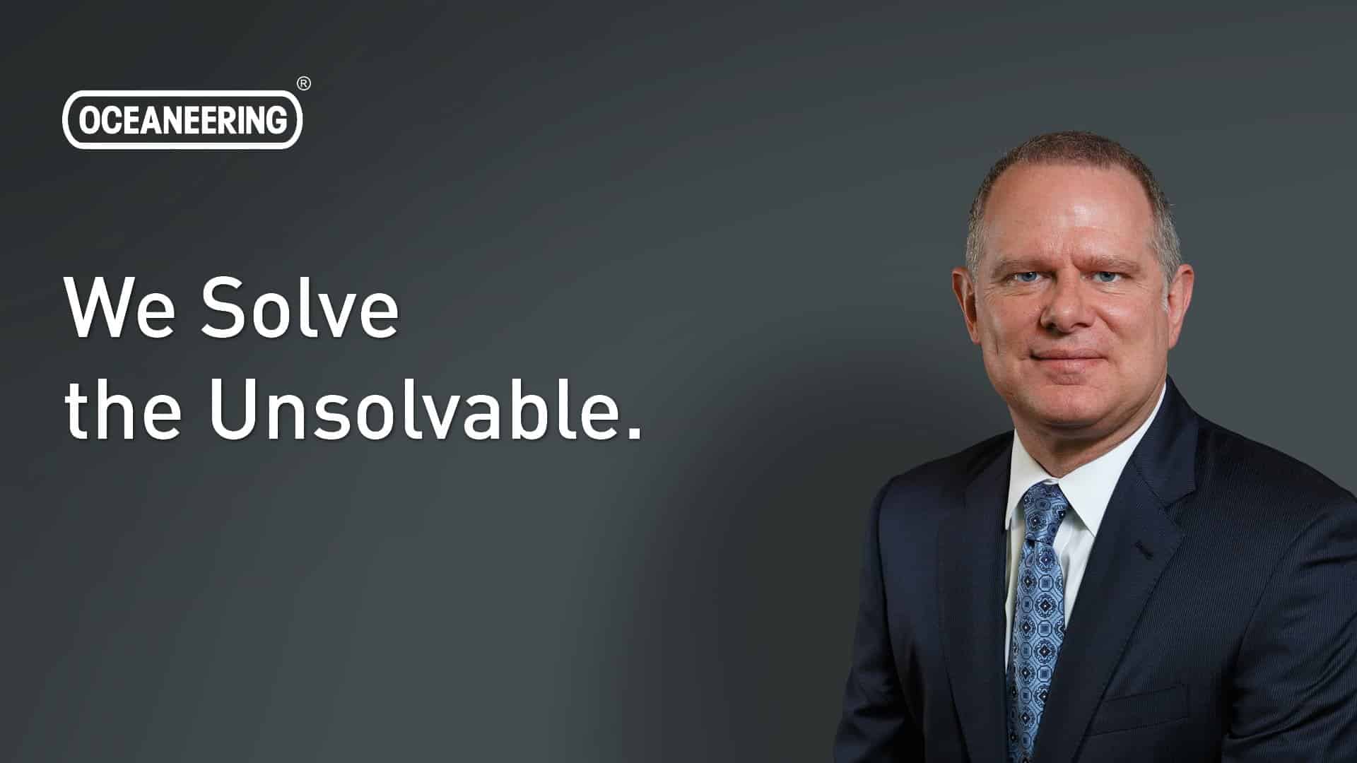 Oceaneering banner with portrait of the CEO and text We Solve the Unsolvable