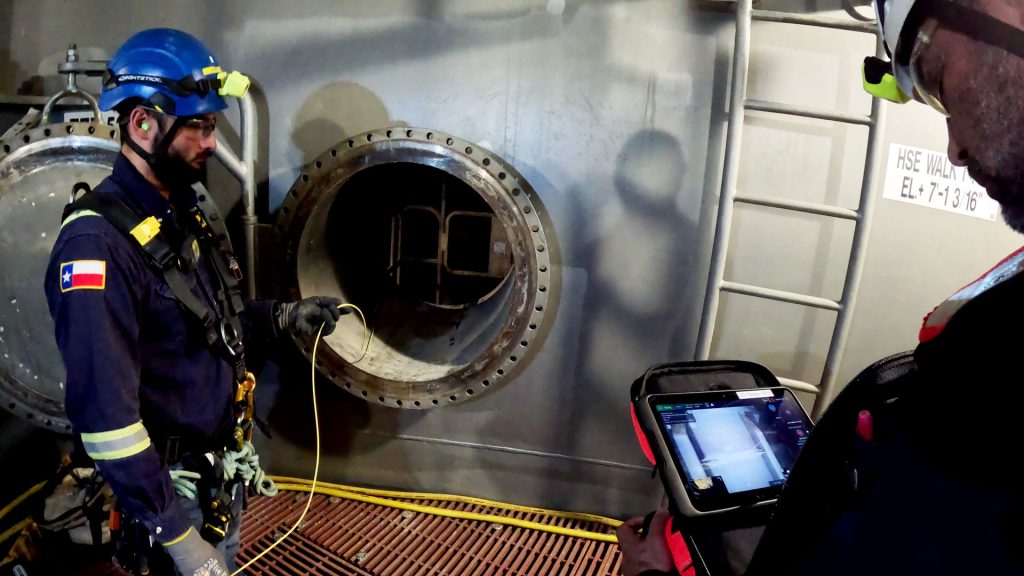 Drone being deployed into open side of hull column tank.