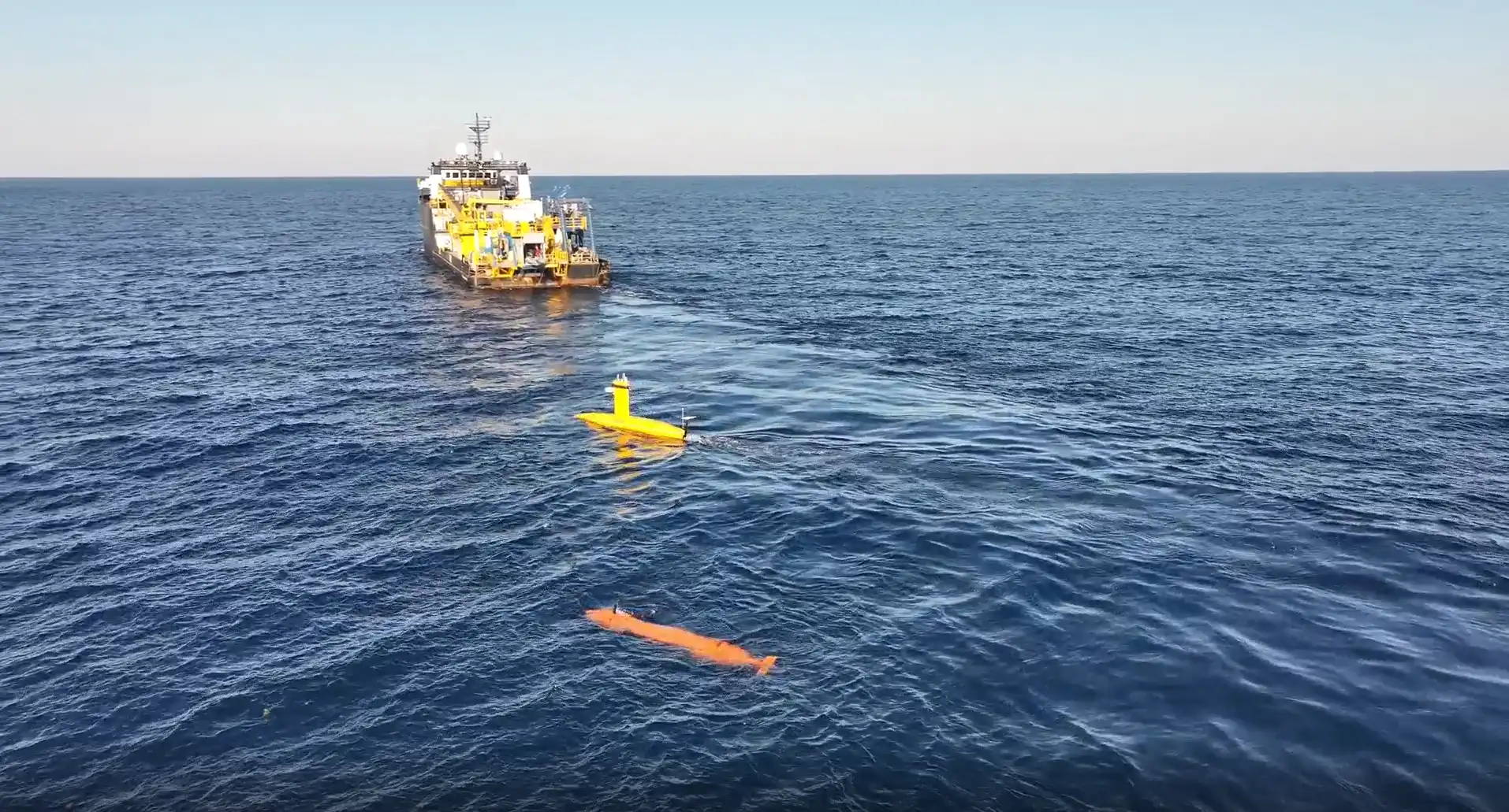 Ocean Intervention II vessel offshore with two smaller towed underwater vehicles behind it completing survey trials.