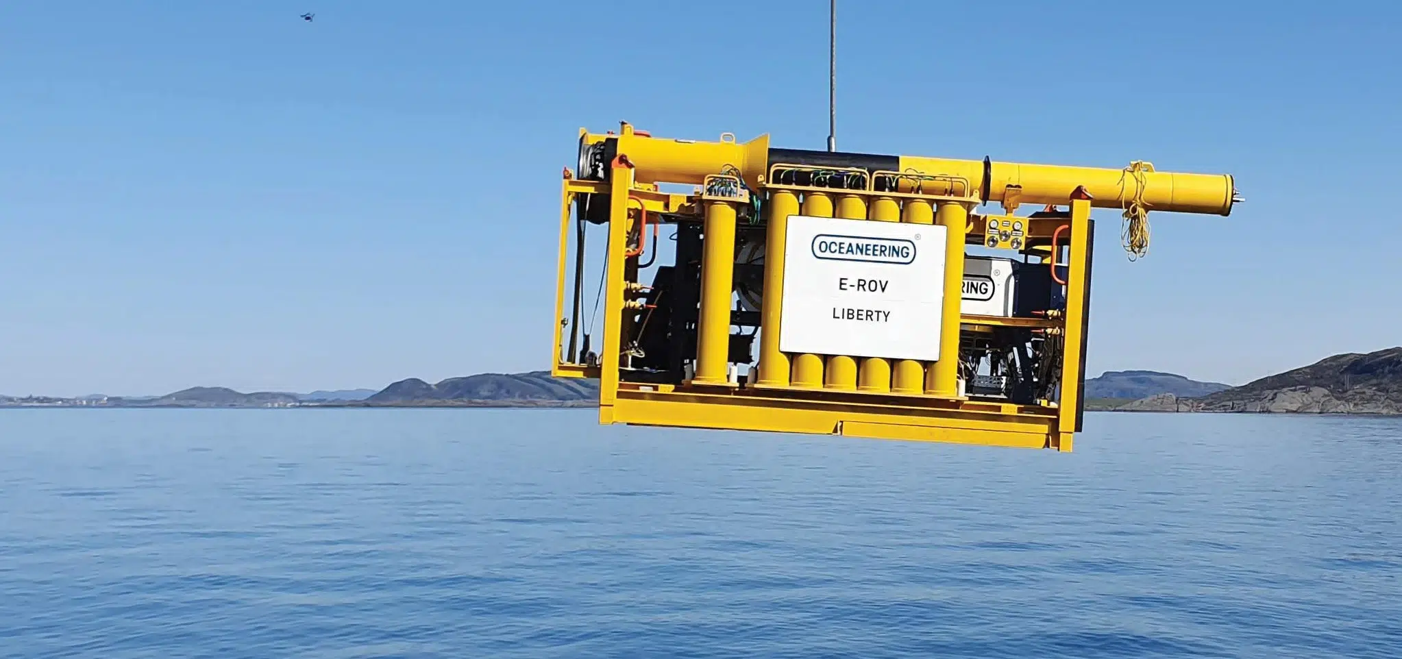 Oceaneering Liberty E-ROV suspended above offshore waters, demonstrating remotely operated vehicle technology for subsea inspection and intervention operations.