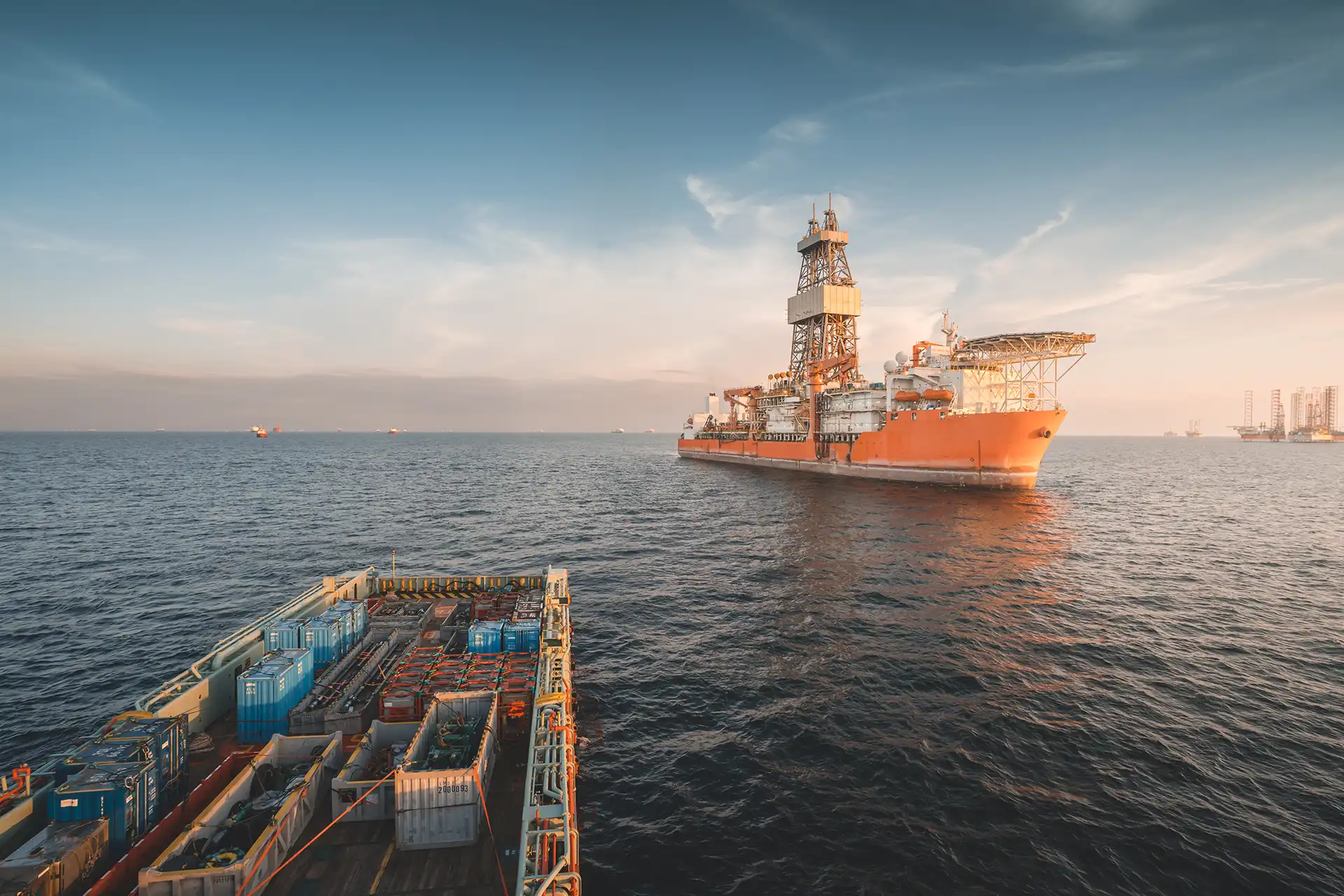 Offshore drilling vessel operating at sea near a support vessel during offshore energy operations