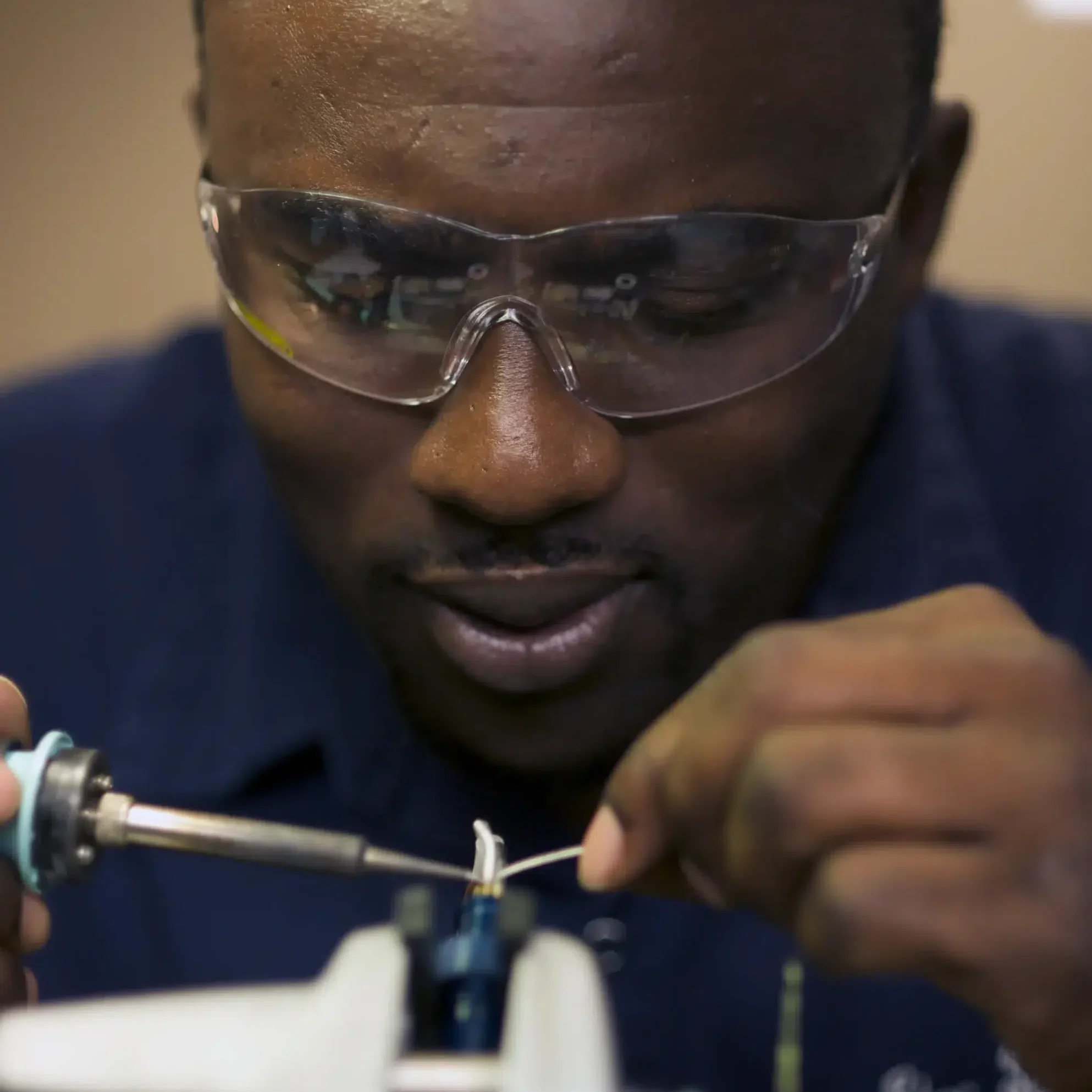 Close up image of an ROV technician working on an ROV tool
