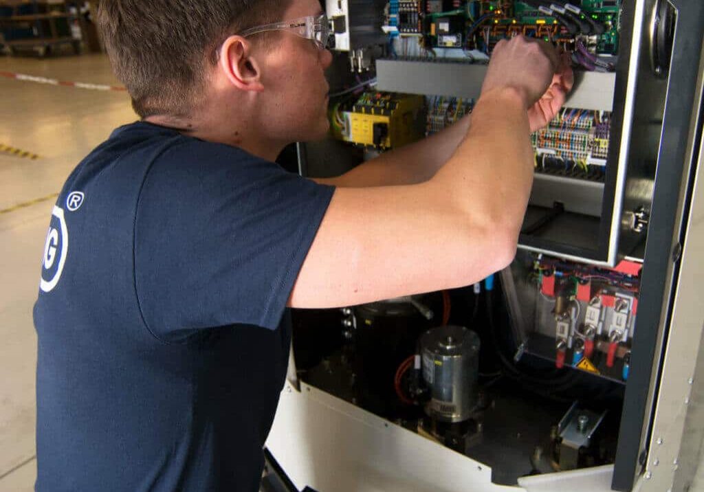 Oceaneering technician doing repair work on a mobile robot