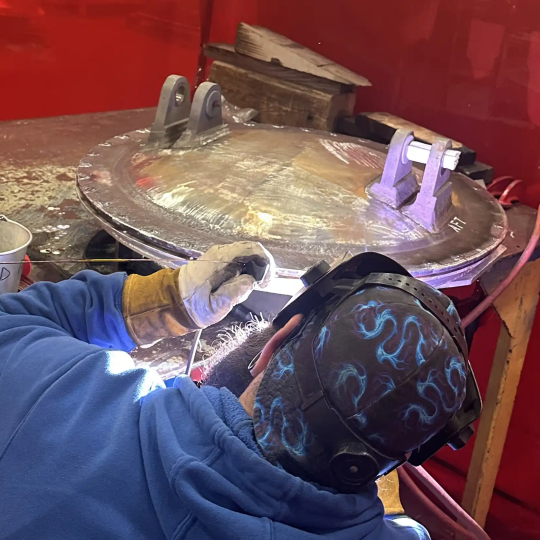 Welder performing base metal repairs on Los Angeles Class Vertical Launch System Hatch