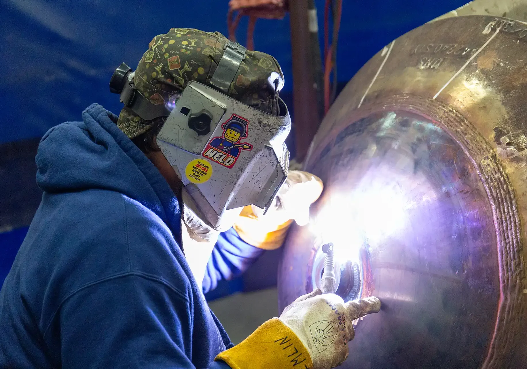 Welder performs precision welding on a submarine part